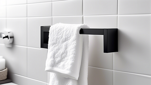 A black and chrome towel bar with a fluffy white towel hanging on it in a modern bathroom with minimalist decor.